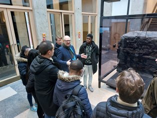 Dr. Michael Farrenkopf stands in front of a group of students and speaks.